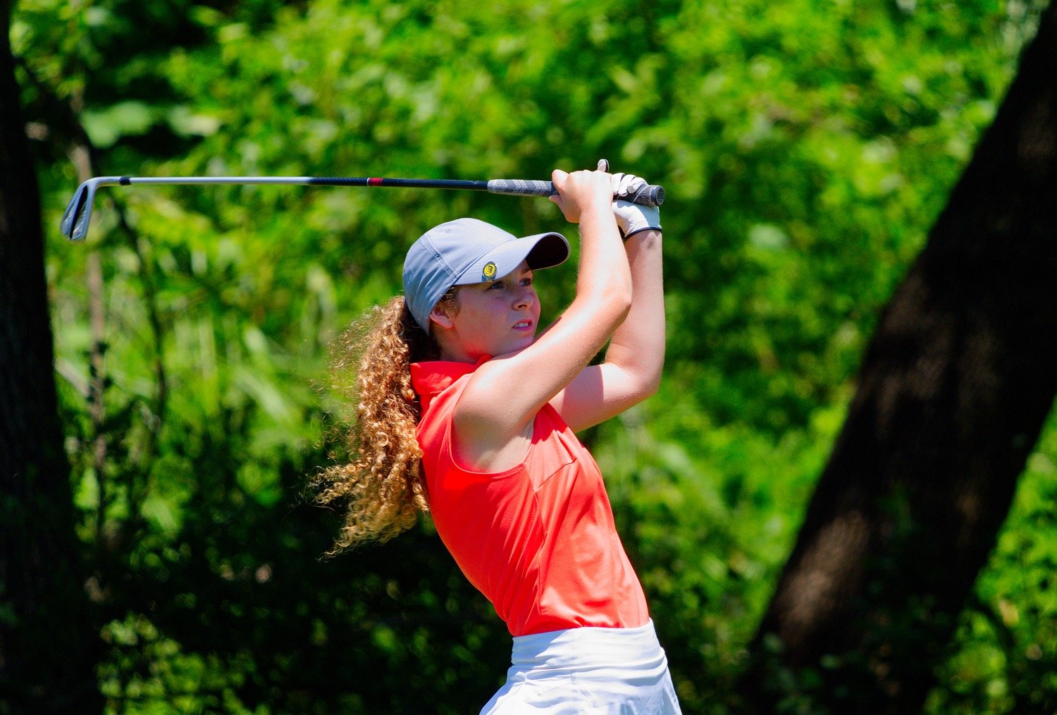 Sunni Ruffin holds her follow-through on a tee shot early in her back nine on her way to second-round 87. [see more orange on greens]